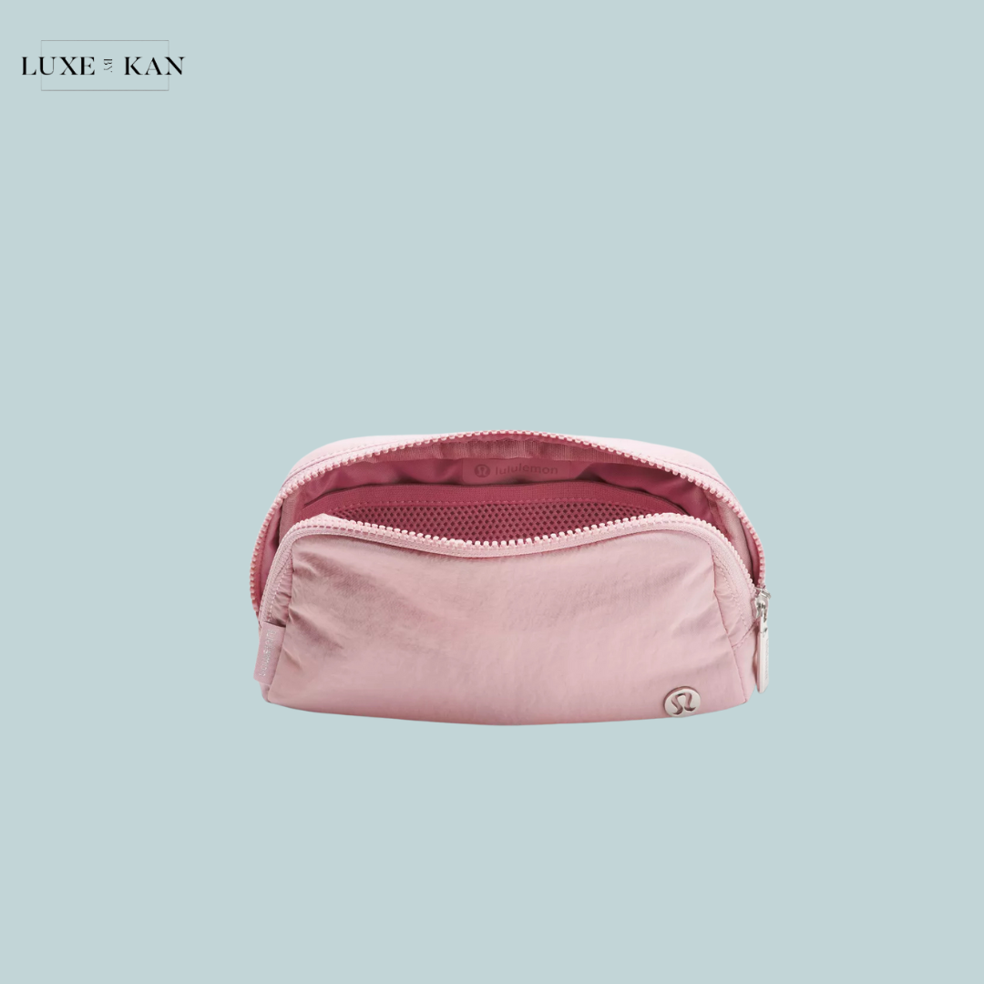 A soft pink pouch with a zippered opening, featuring an inner mesh pocket.
