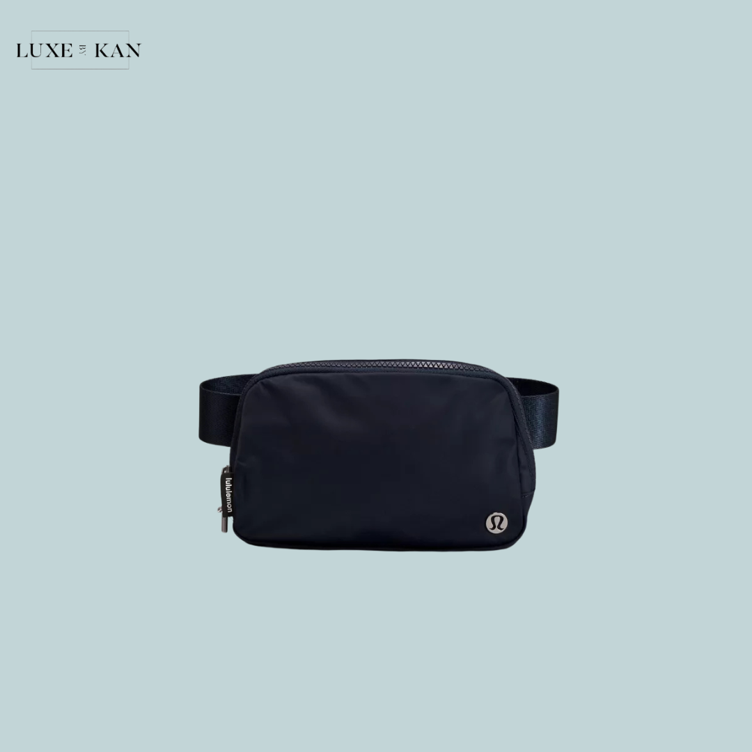 A sleek black travel pouch with a zip closure and adjustable strap, featuring a subtle Lululemon logo on the front.