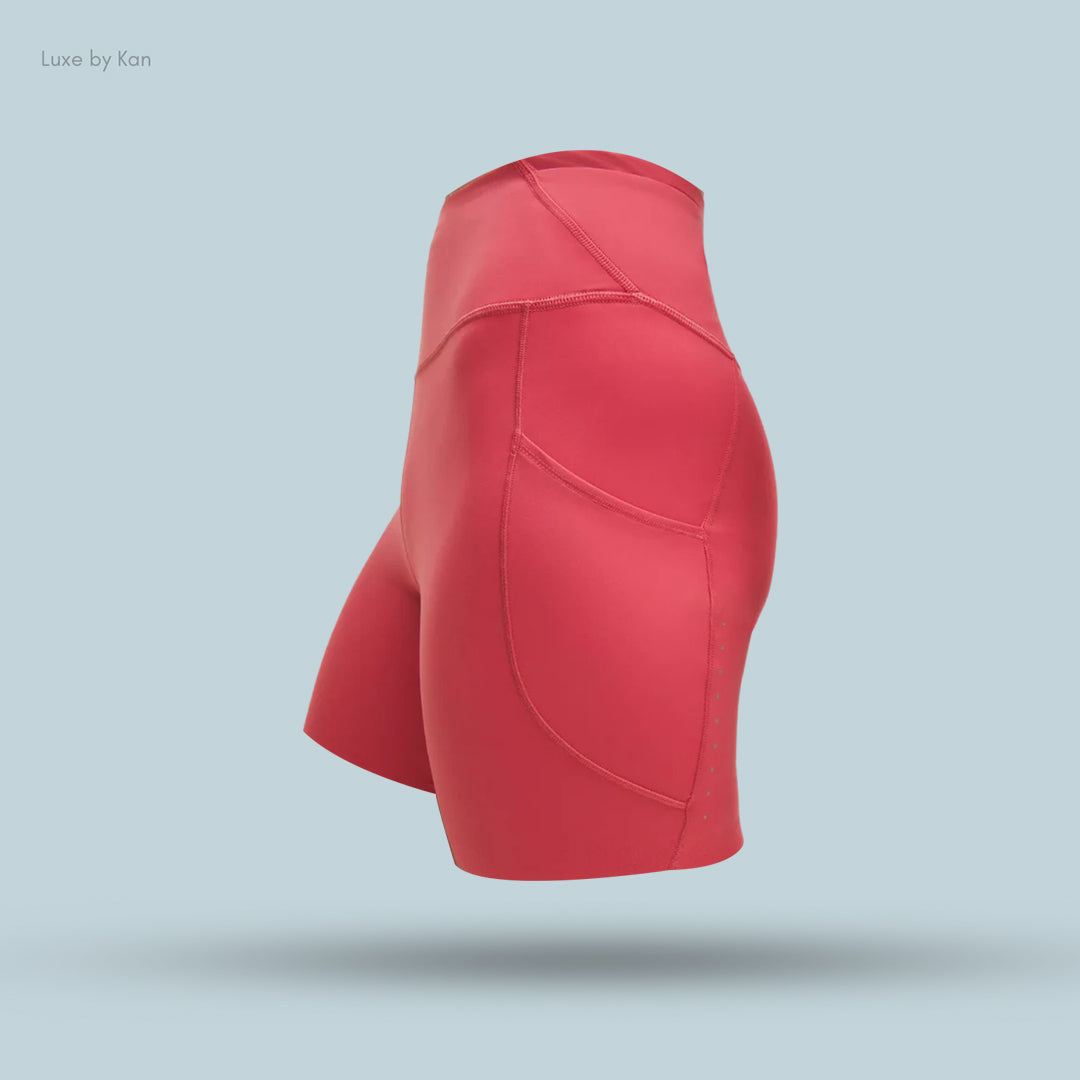 Side view of vibrant pink high-waisted shorts with sleek stitching.