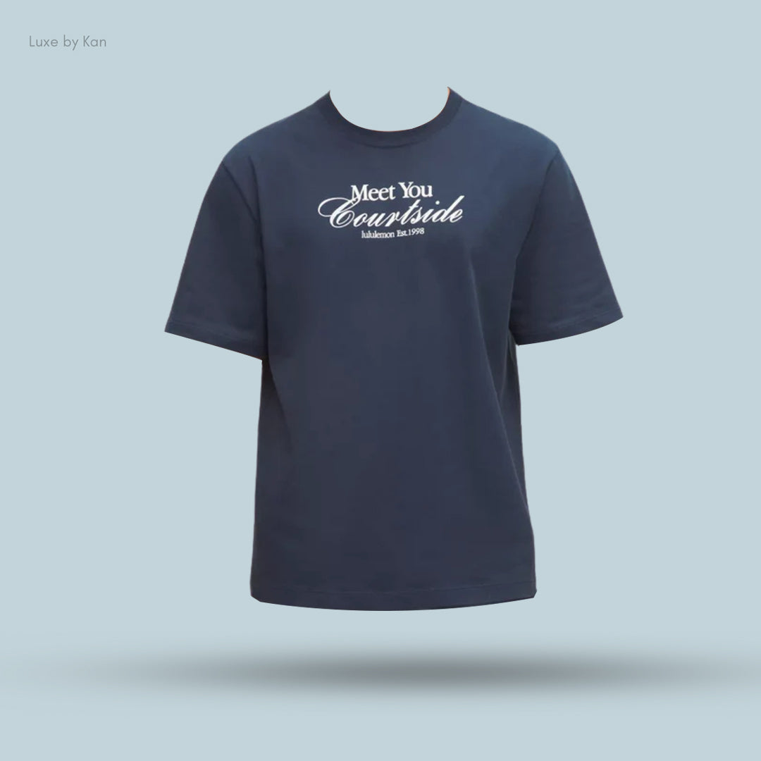 Navy blue t-shirt featuring white text that reads "Meet You Courtside" and "lululemon Est. 1998" on the fron.