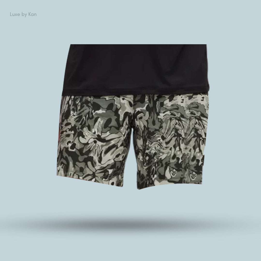 Black short-sleeve shirt paired with green and gray camo shorts.
