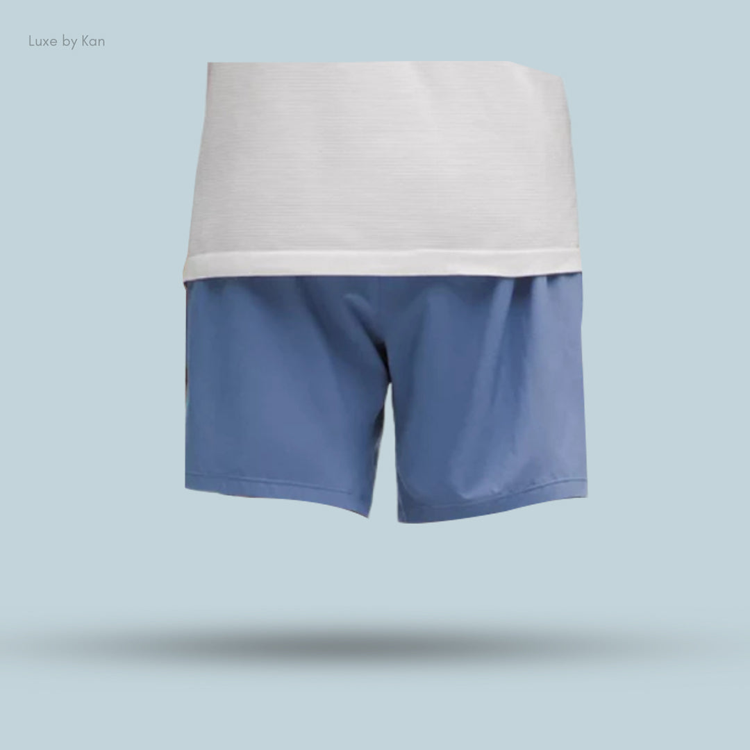 Back view of a person wearing light blue shorts with a white shirt,