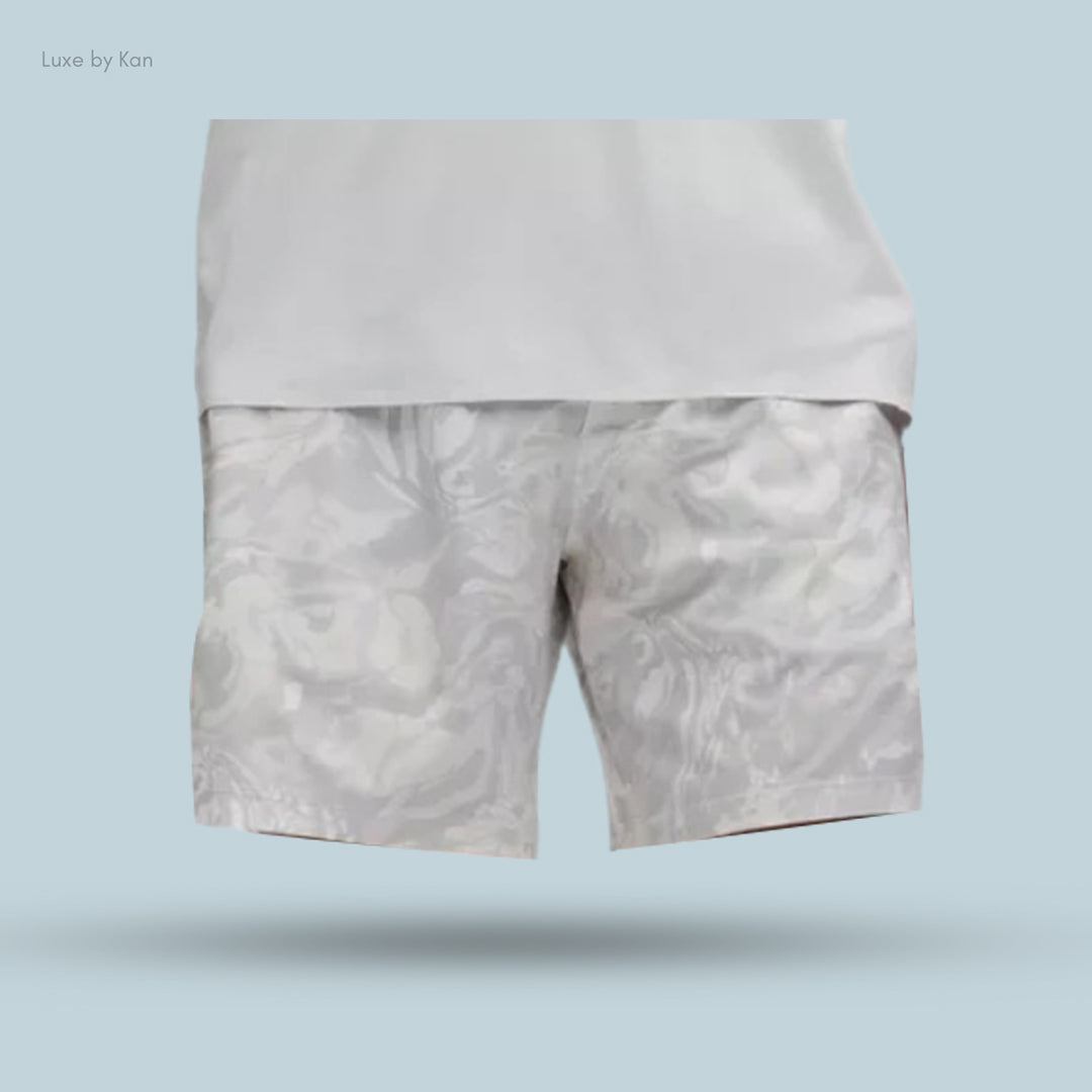 Stylish gray shorts with a subtle abstract pattern, paired with a fitted white shirt.