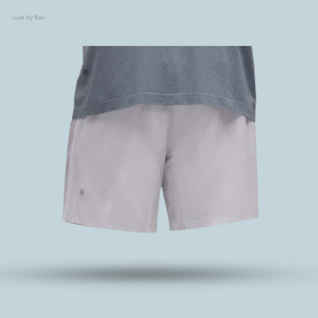 Short light gray shorts paired with a loose blue top.