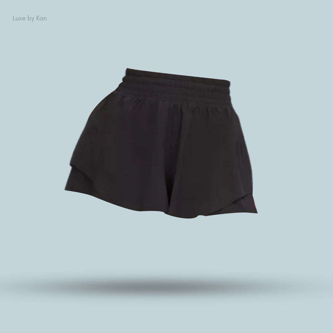 Black athletic shorts with a flared design, showcasing a modern, stylish look.