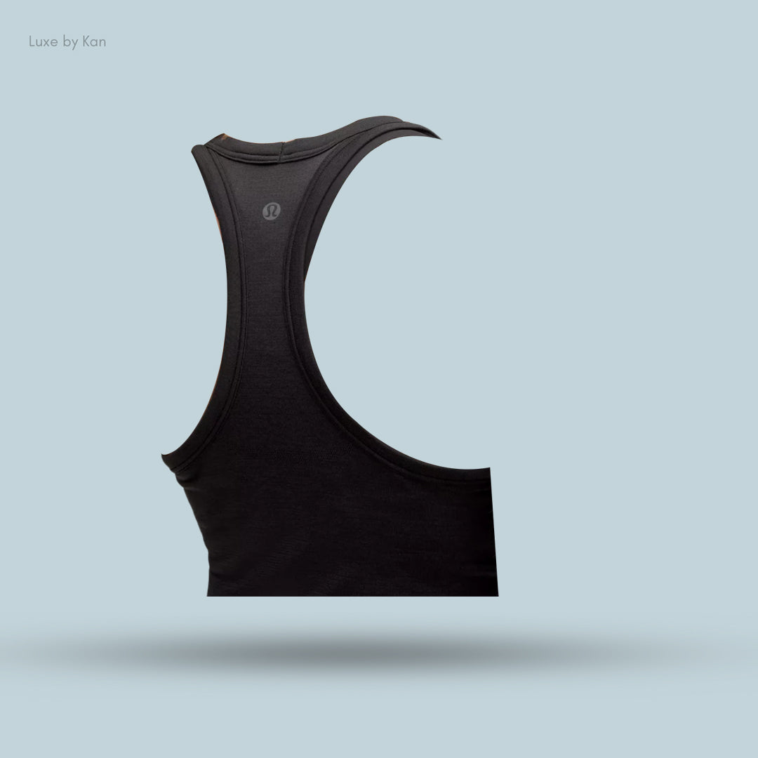 Black athletic tank top displayed against a light blue background, featuring a sleek design and the Lululemon logo.