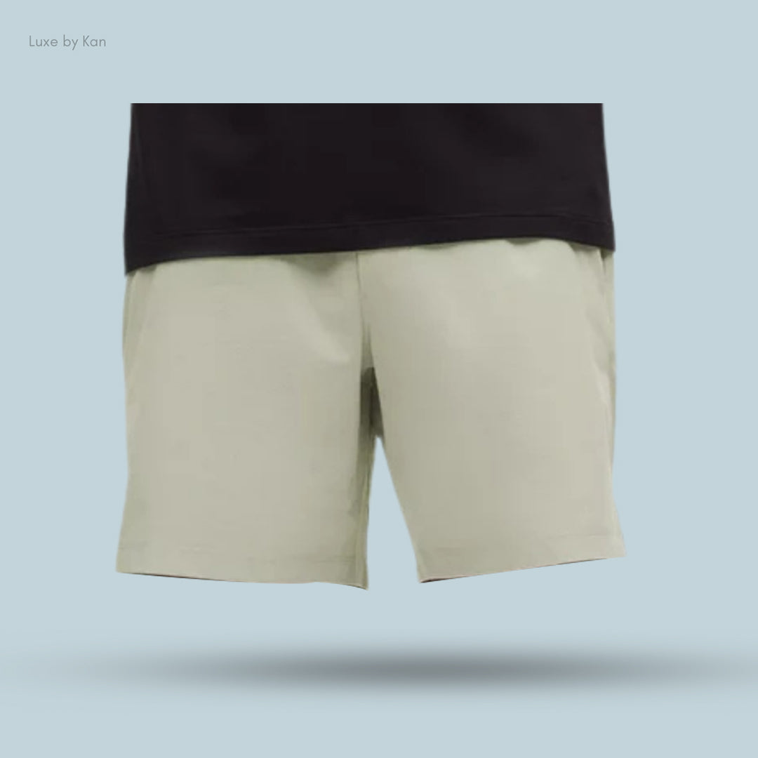 Lululemon Zeroed In Linerless Short 7" paired with a black top, suspended against a soft blue background to showcase a casual style.