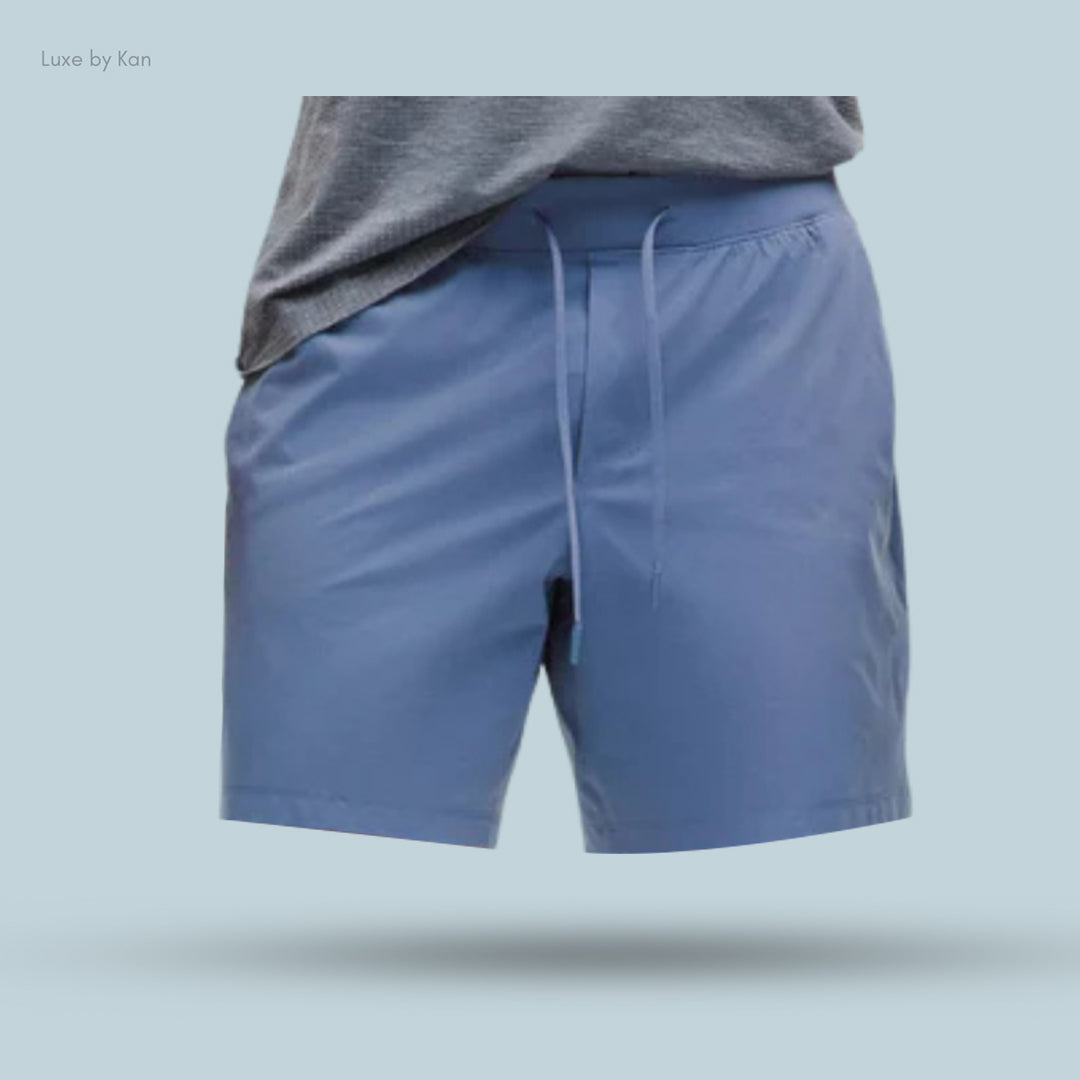 Blue Lululemon Zeroed In Linerless Short 7", designed for training, featuring a drawstring waistband and styled casually with a grey T-shirt.