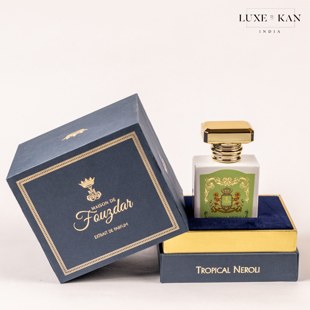 Elegant perfume bottle inside stylish packaging, featuring "Maison de Fouzdar" and "Tropical Neroli" labels, with gold accents.