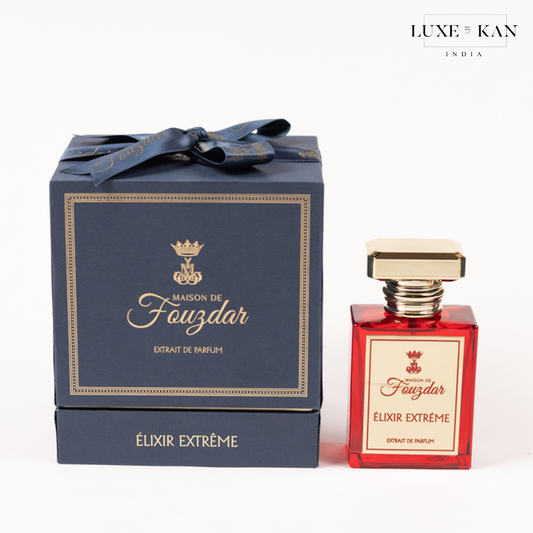 A luxurious red perfume bottle beside its elegant navy blue box, both labeled "Maison de Fauzdar ÉLIXIR EXTREME."