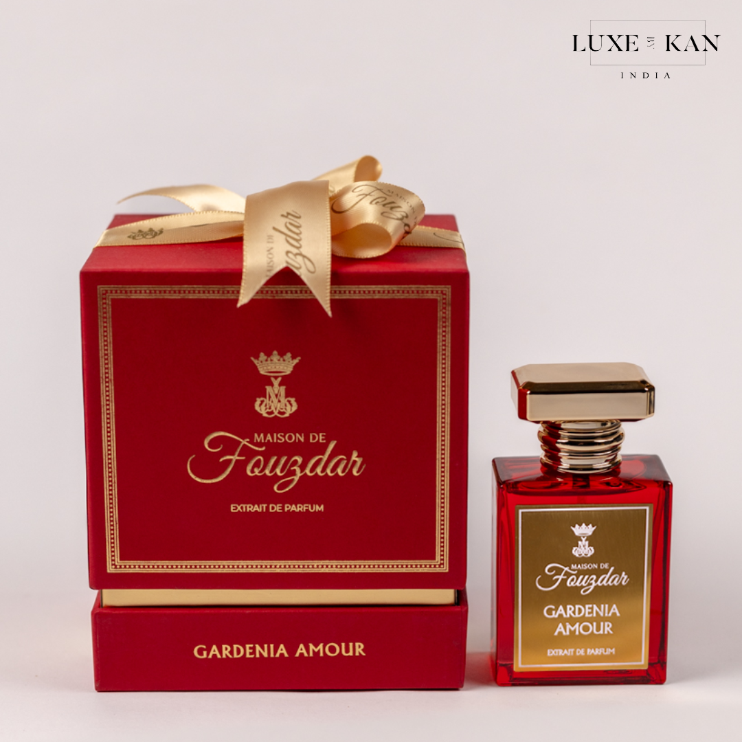 Elegant red box with gold accents containing "Gardenia Amour" perfume bottle, adorned with a luxurious ribbon.