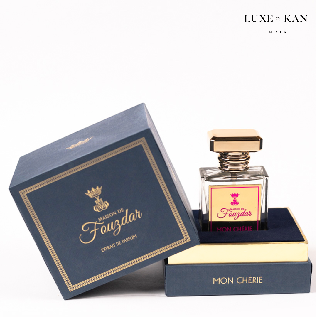 Elegant perfume bottle labeled "Mon Chérie" in a stylish blue and gold box, half-open showcasing its luxurious packaging.