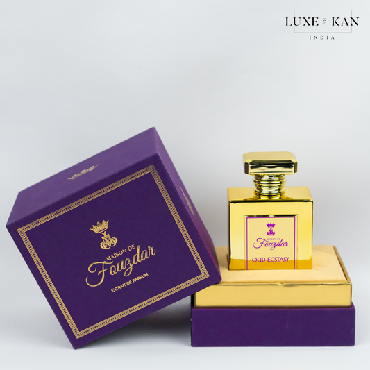 A luxurious gold perfume bottle labeled "Oud Ecstasy" beside a purple box, showcasing elegant packaging by Maison de Fauzdar.