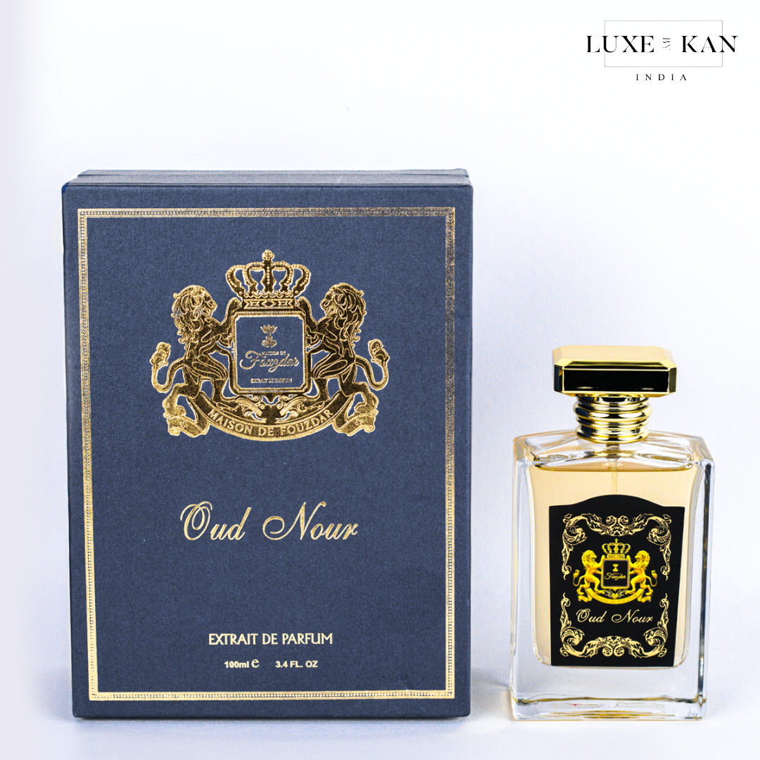 Maison de fouzdar oud nour perfume bottle next to a luxurious blue box.
