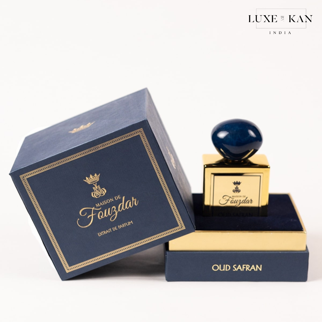 A luxurious perfume bottle by Maison de Fauzdar, elegantly displayed with its navy blue box, labeled "oud safran."