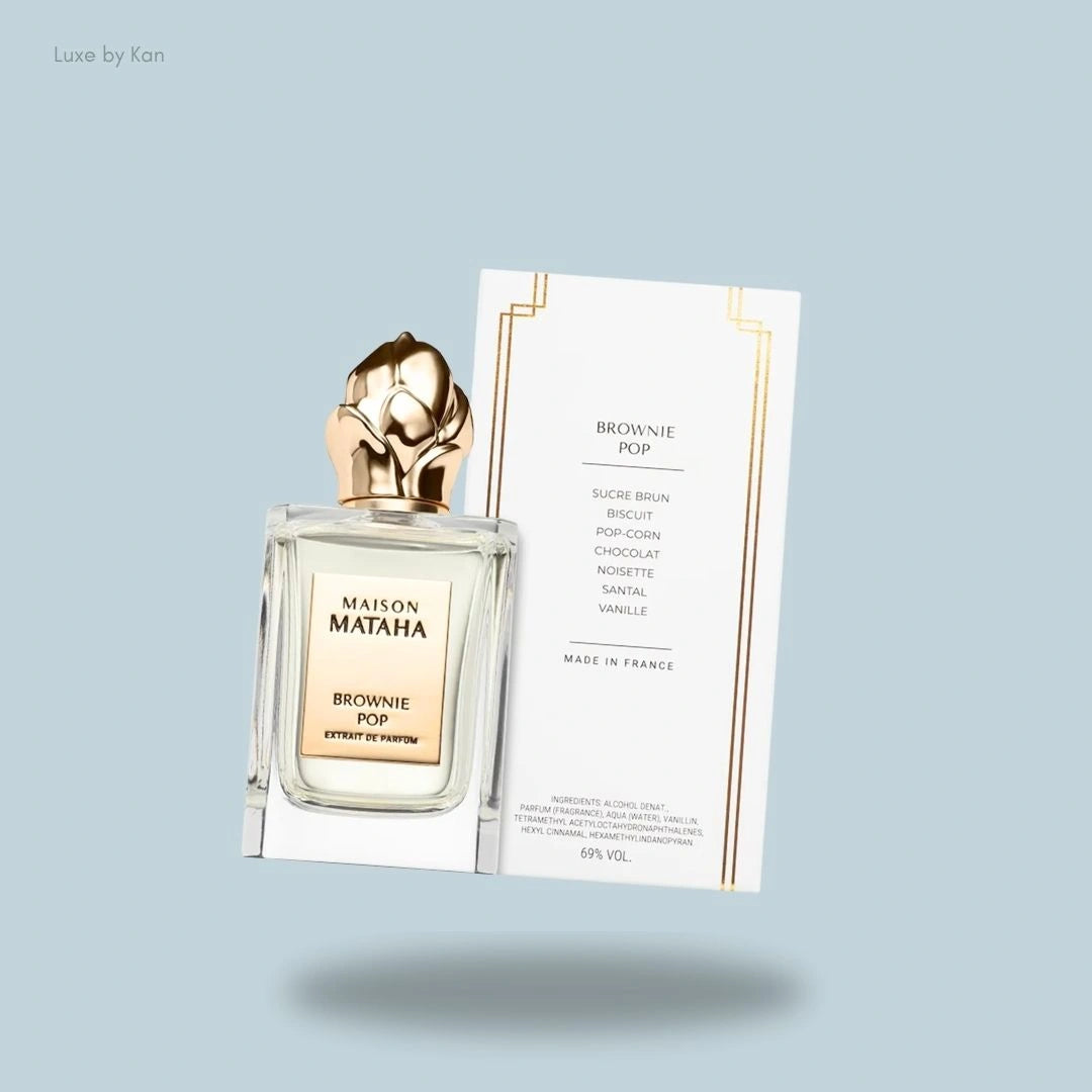 Maison Mataha Brownie Pop extrait de parfum, featuring a square bottle with a gold floral cap, next to a card with the scent's ingredients.
