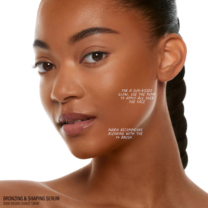 A close-up of a person's ear and neck, showcasing smooth skin and a braided hairstyle. Contains product branding for bronzing serum.