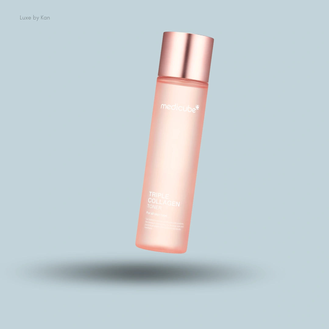 A pink Medicube Triple Collagen Toner 4.0 bottle floats over a light blue background with a soft shadow.