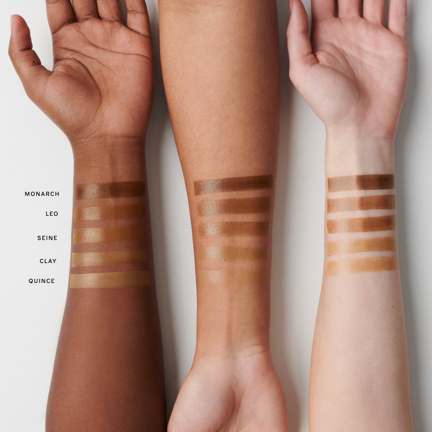 Three arms with different skin tones show swatches of makeup in shades labeled Monarch, Leo, Seine, Clay, and Quince.