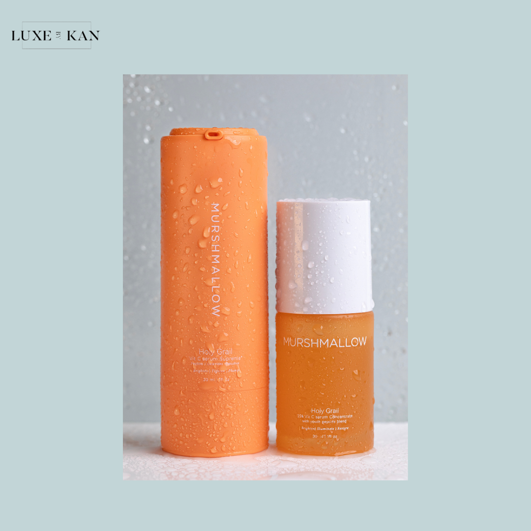 Two Murshmallow skincare products in vibrant orange color packaging.