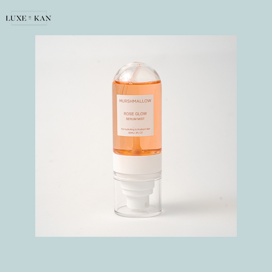 Bottle of Murshmallow Rose Glow Serum Mist with pink liquid.