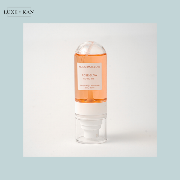 Bottle of Murshmallow Rose Glow Serum Mist with pink liquid.
