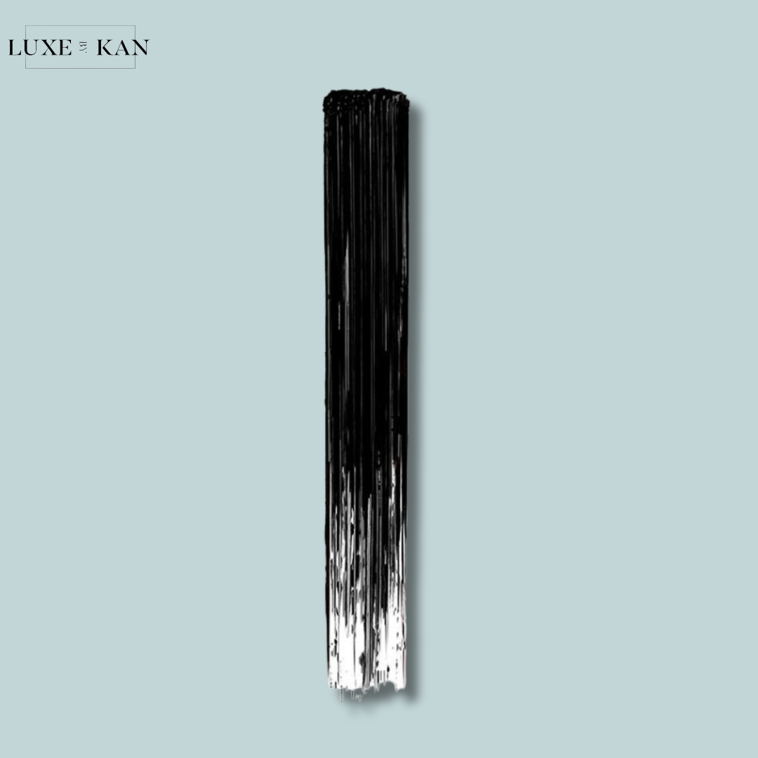 A vertical brush stroke in black and white against a light blue background, showcasing a sleek and artistic design.