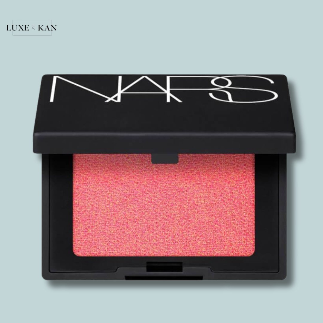 A compact NARS blush featuring a bright pink shade inside a sleek black case.