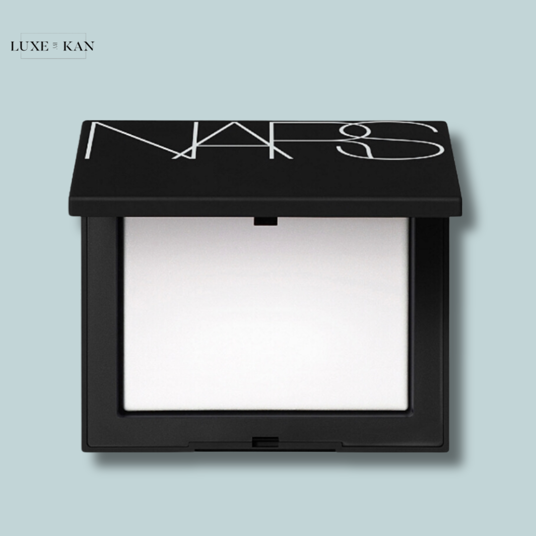 Black NARS compact with a sleek design, featuring a white interior and the brand's logo elegantly embossed on the lid.