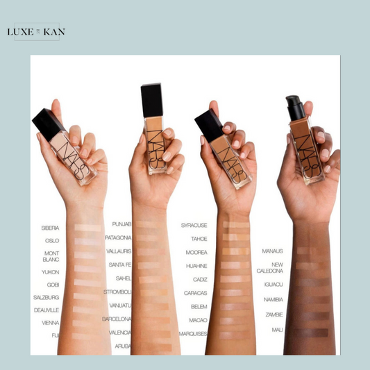 Three hands holding NARS foundation bottles with swatches of various skin tones alongside them, labeled for reference.