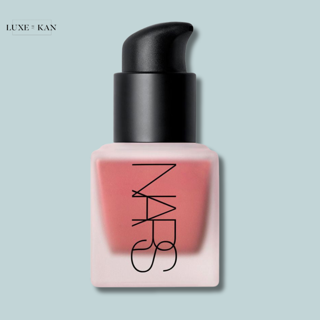 A sleek NARS cosmetic bottle featuring a black pump top and soft pink base, labeled prominently with the NARS logo.