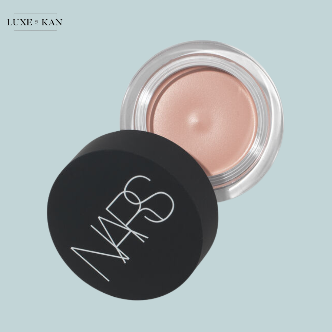 Open NARS cream blush pot with a soft peach shade.