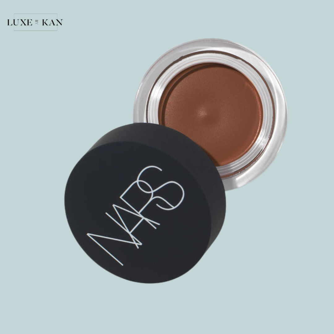 A jar of NARS bronzing cream with a dark brown shade.