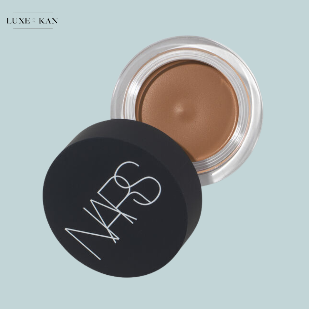 NARS brown cream product in a clear jar with a sleek black lid.