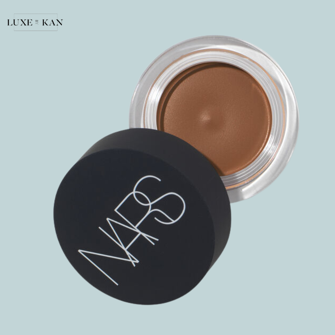 A jar of NARS cream in a rich brown shade, with the lid slightly open.