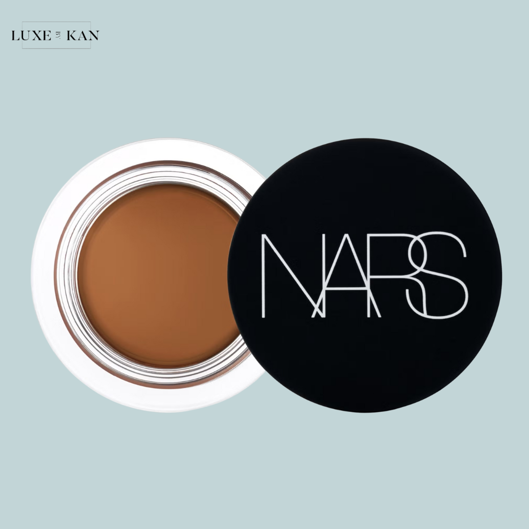 NARS cream concealer in a black pot with the logo facing up, showcasing a warm brown shade.