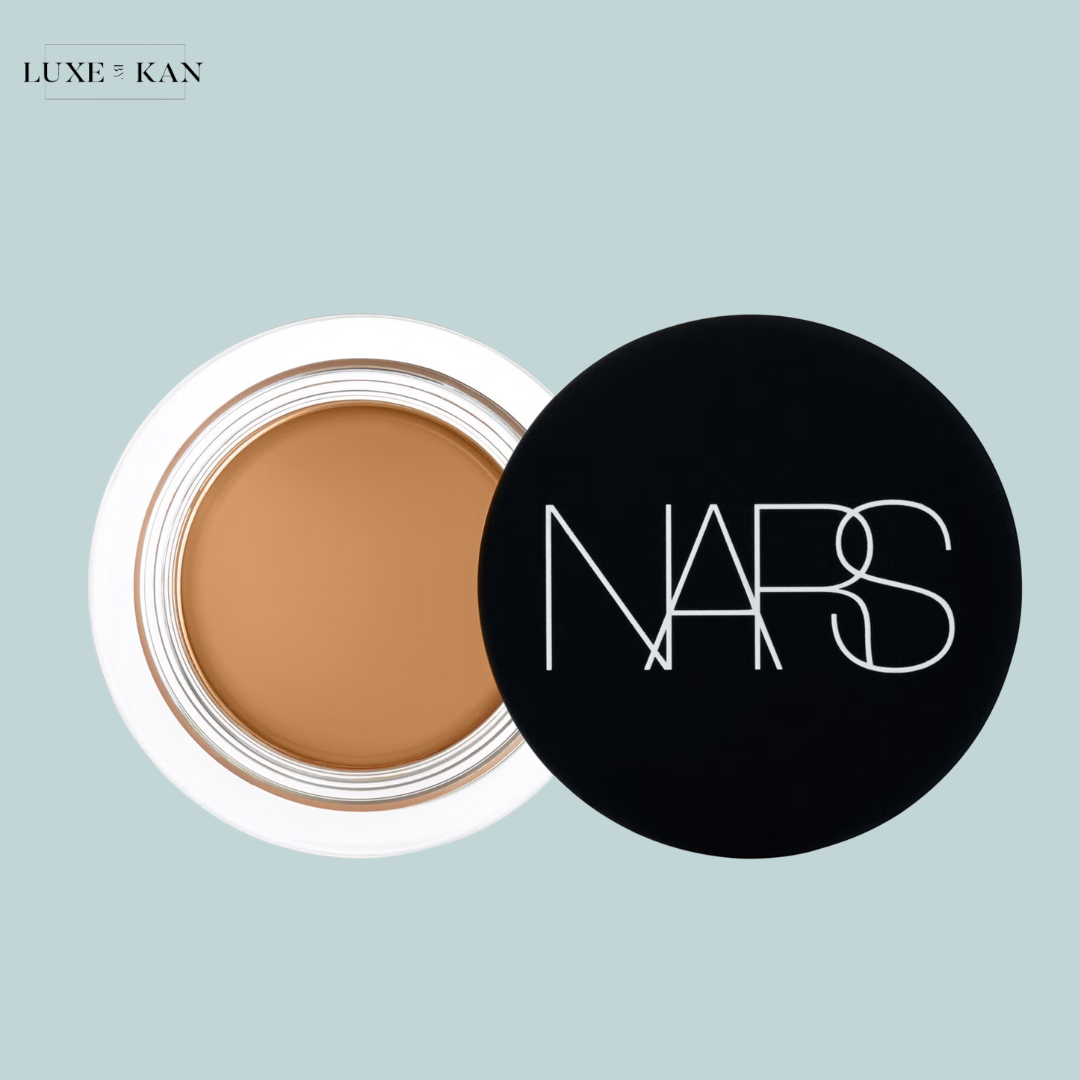 A pot of NARS concealer with a creamy tan shade, lid open.