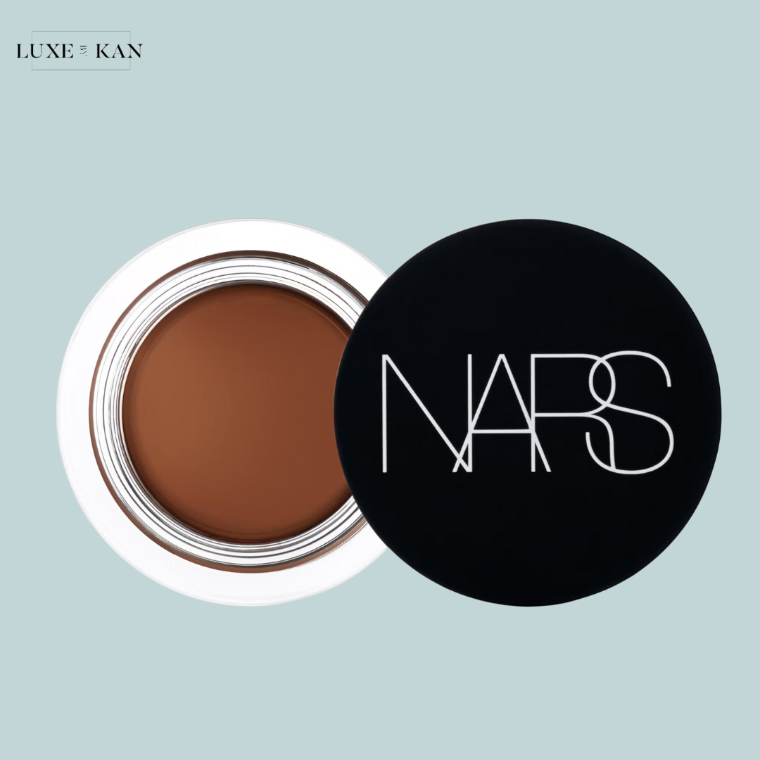A NARS cream bronzer in a black compact, revealing a smooth, rich brown product.