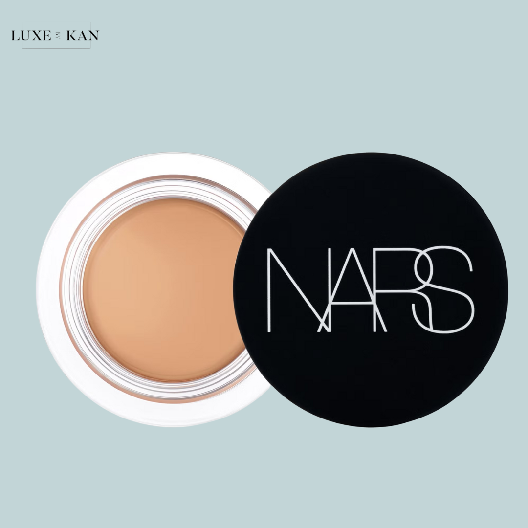 A NARS concealer jar with a smooth, creamy texture, partially opened.