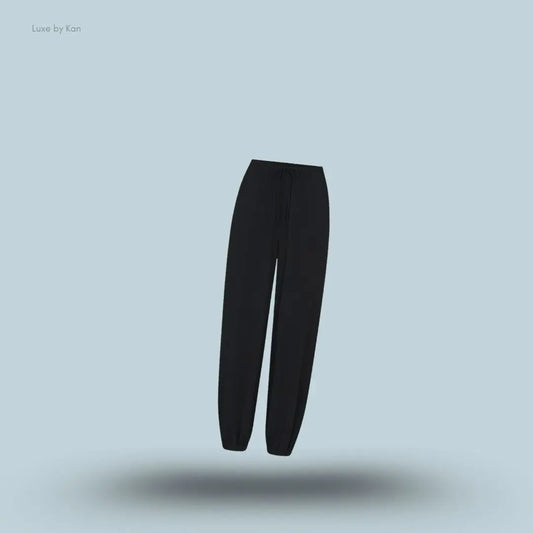 SKIMS Sleep Balloon Pant in Onyx, flat lay on light blue background