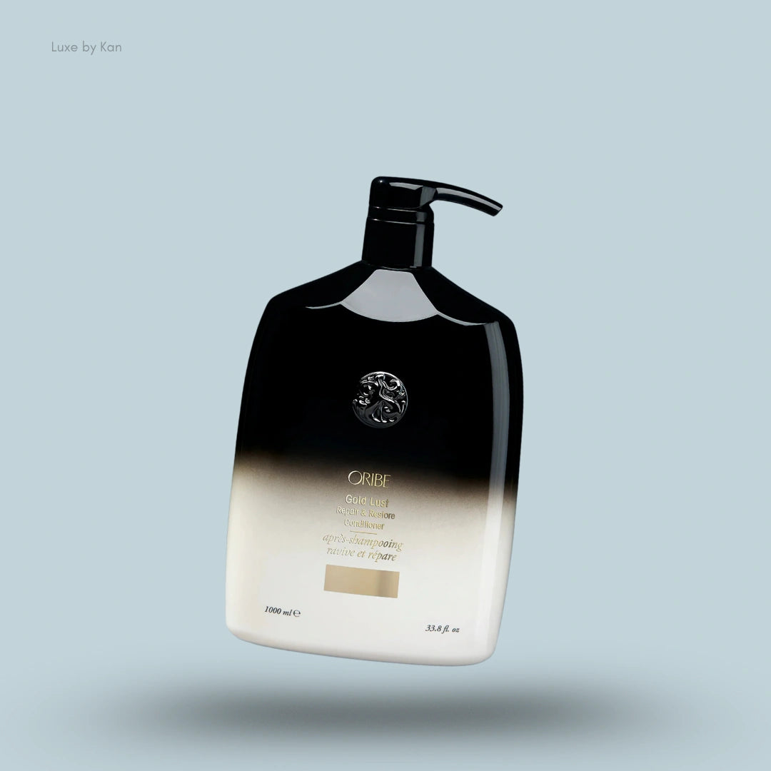 Oribe Gold Lust Repair and Restore Conditioner shown in black and off-white bottle with a pump dispenser.