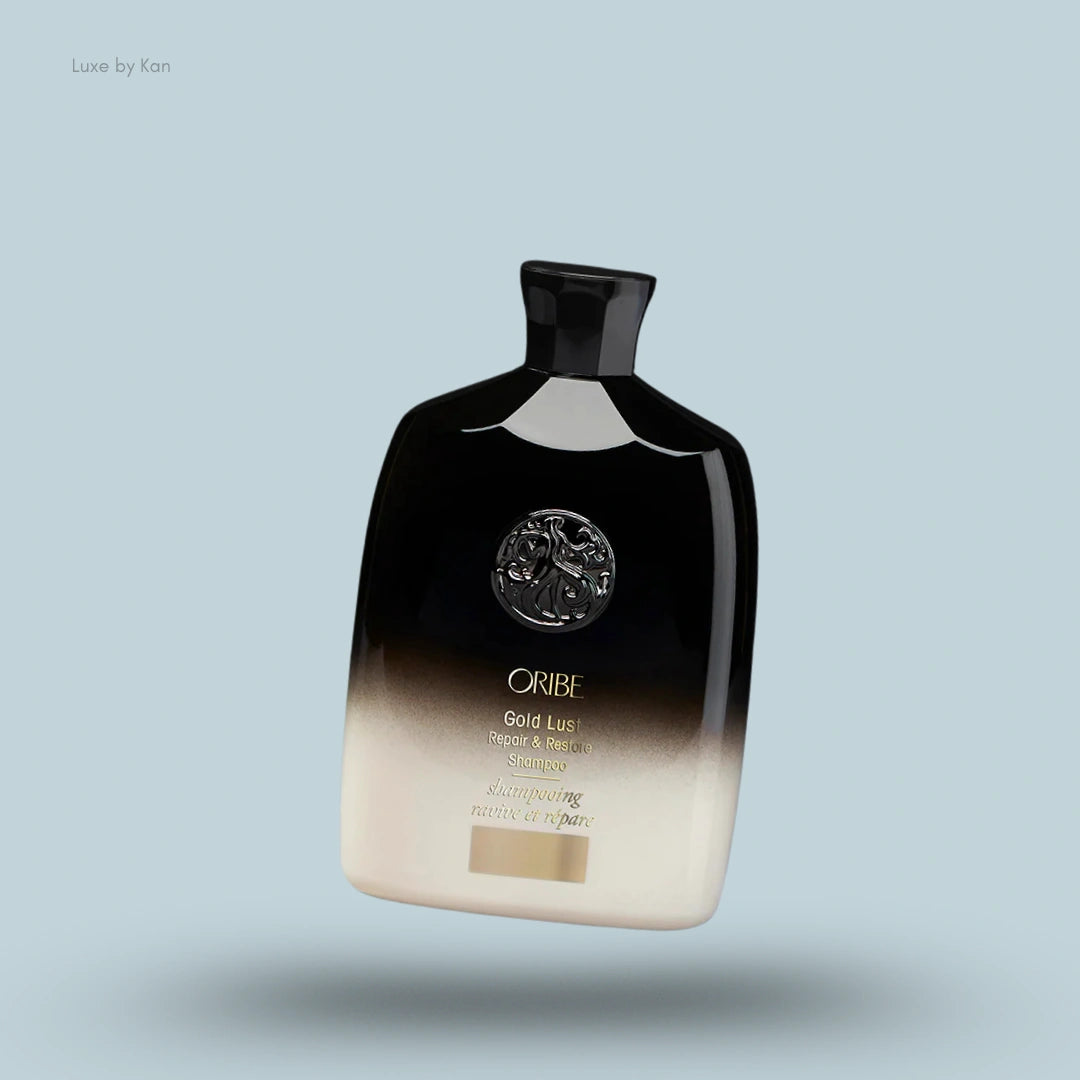 Oribe Gold Lust Repair & Restore Shampoo bottle with black and beige gradient design.