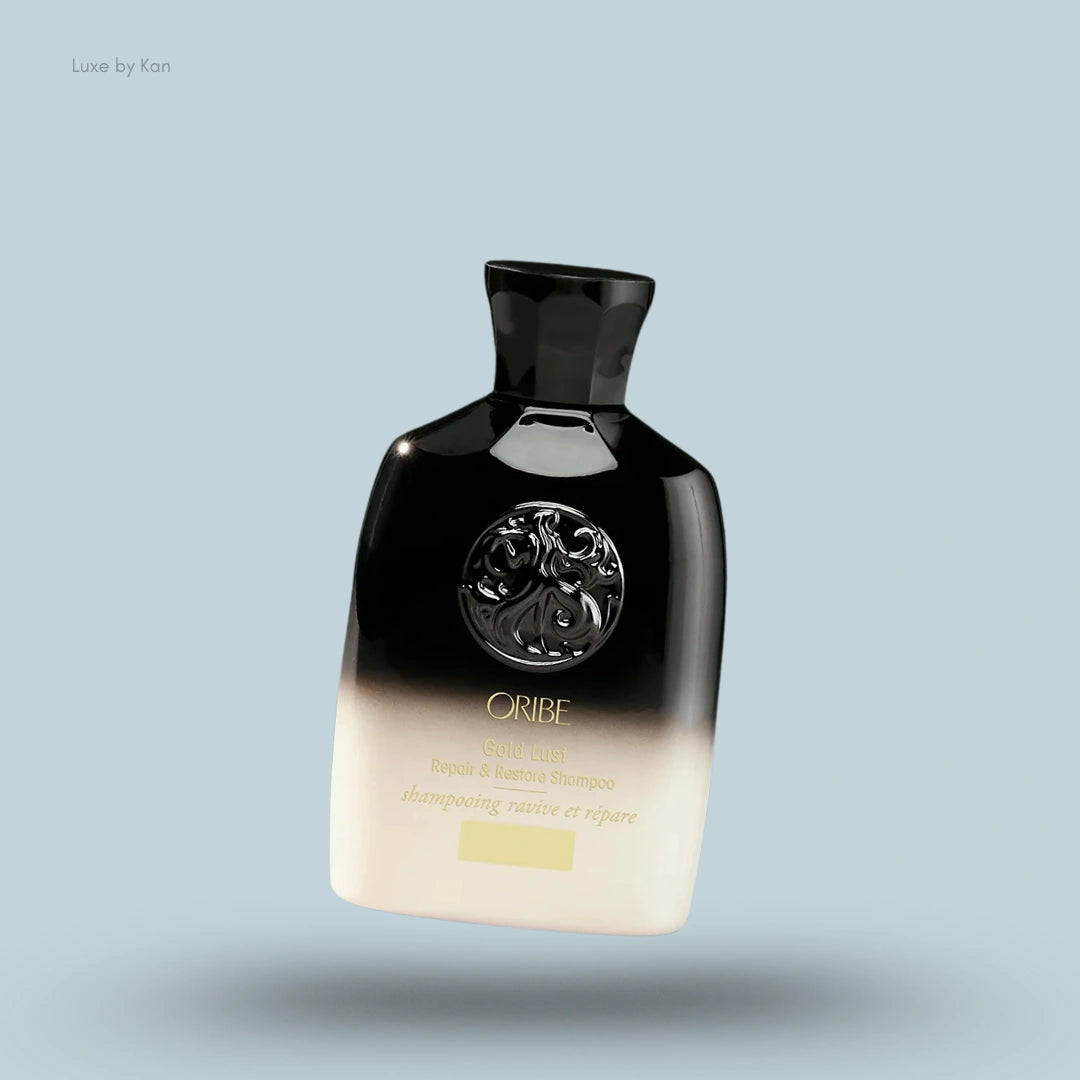 Oribe Gold Lust Repair & Restore Shampoo bottle with gradient design and gold accents.