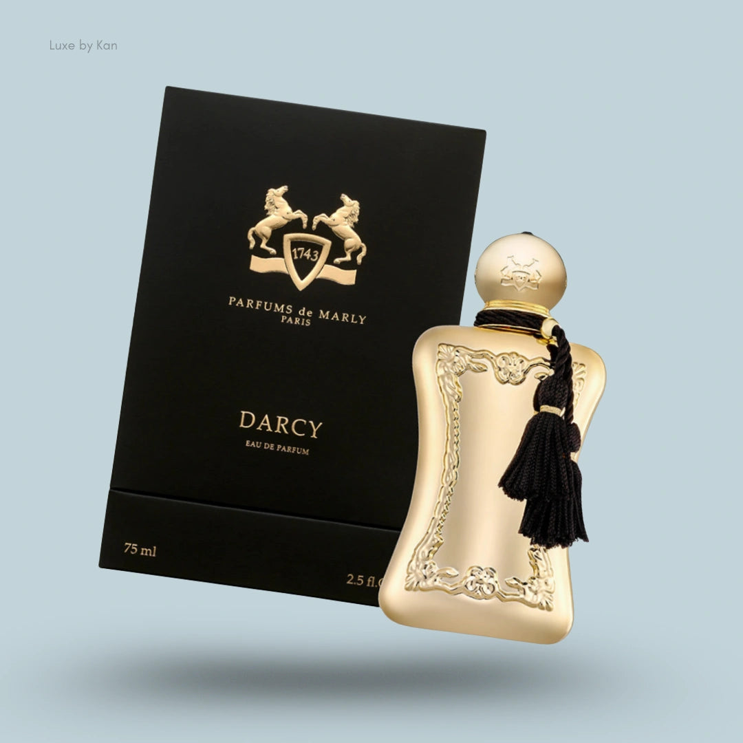 Parfums de Marly Darcy Eau de Parfum in gold flacon with black tassel, positioned next to its black and gold box.