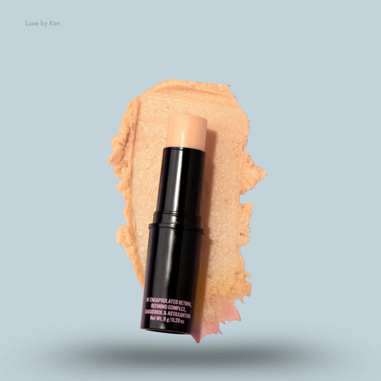 Peace Out retinol face stick displayed on a swatch of its light orange ingredient.