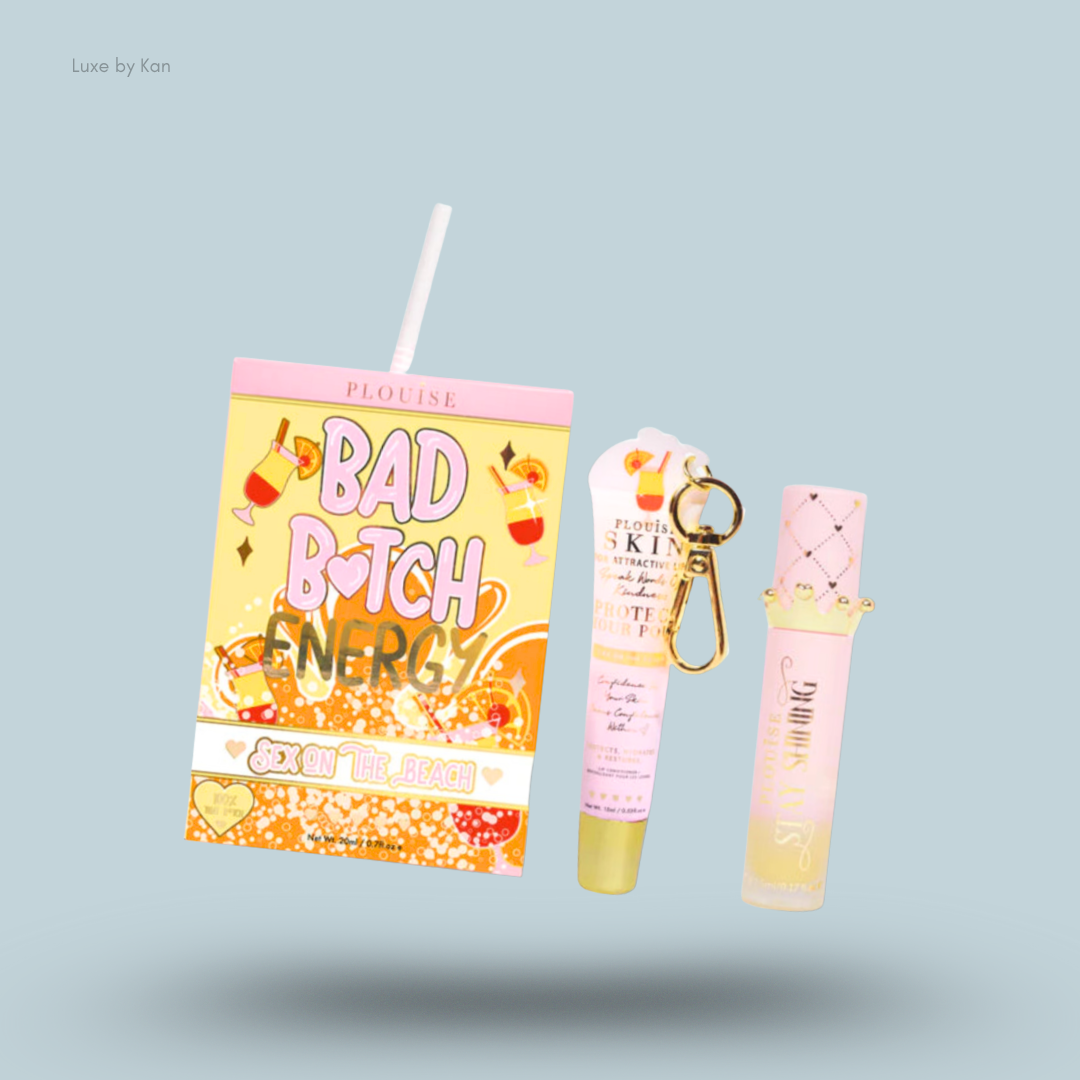 Plouise Bad Bitch Energy lip duo, packaged in a juice box themed container next to a lip gloss with keychain and lip oil.