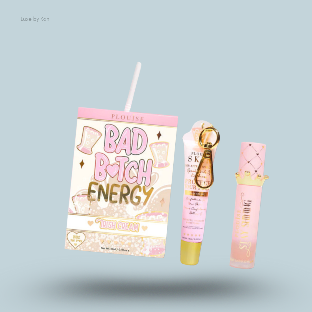 Plouise Bad Bitch Energy lip duo consisting of a lip balm tube and lip plumper gloss with crown on the cap presented side by side with their box which is shaped like a carton of juice.