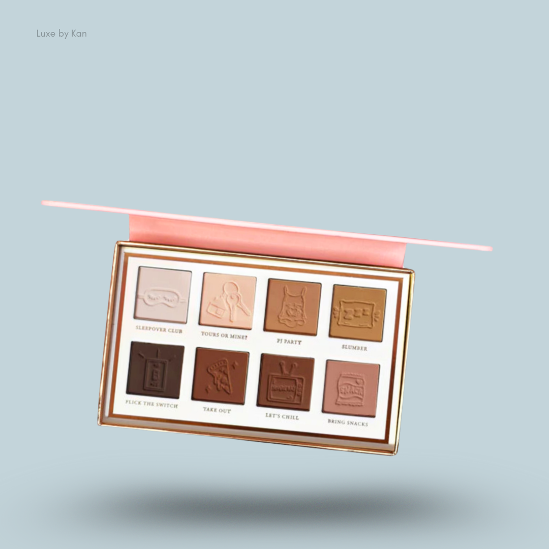 Close-up of a Plouise Love Tapes Beneath The Sheets eyeshadow palette, featuring eight shades with embossed designs and names.