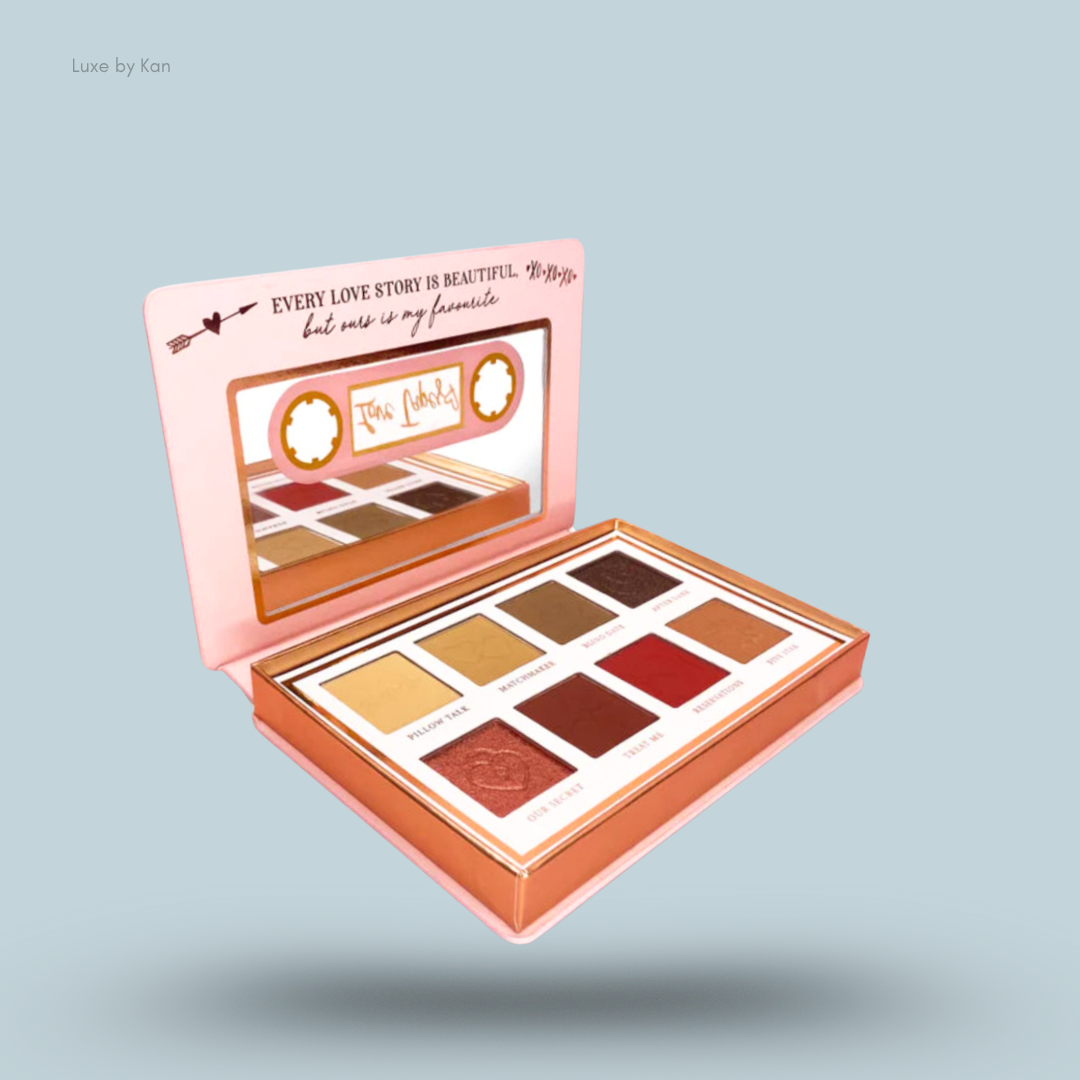 Open eyeshadow palette, designed to resemble a cassette tape, with romantic shade names such as "Pillow Talk" and "Our Secret".