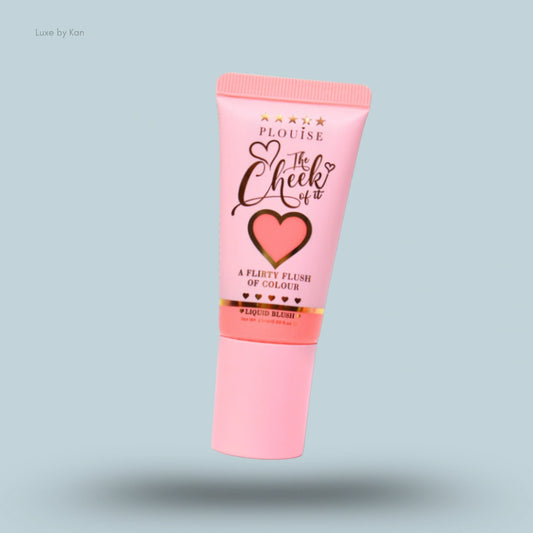 Cosmetic tube of Plouise The Cheek of It liquid blush in light pink packaging, and the product description is written in black and gold cursive font.